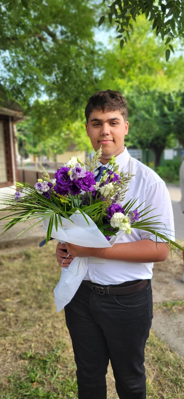 Graduate holding flower bouquet