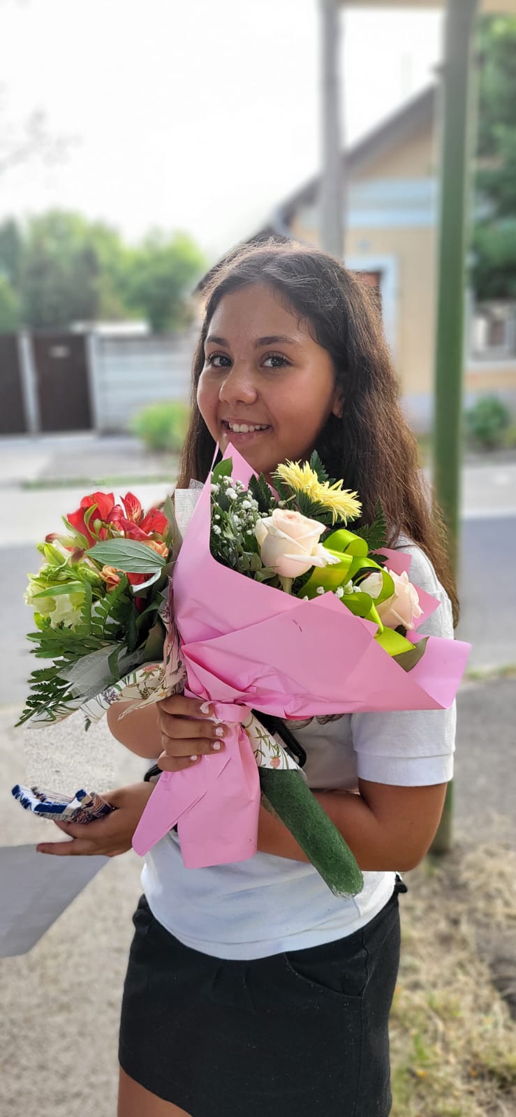 Graduate girl holding flower bouquet